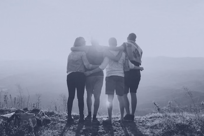 Friends with arms around each other